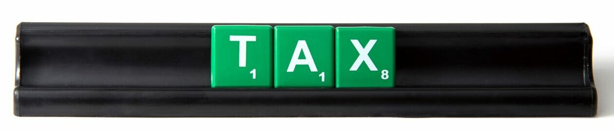 Green tiles on a black holder spelling the word Tax on the Pro Tax & Accounting Frequently Asked Questions page