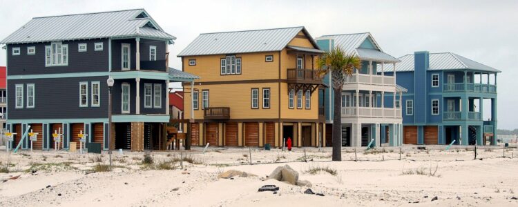 4 Houses On The Beach With Sand And Dunes Representing Why Not To Invest An IRA In Real Estate